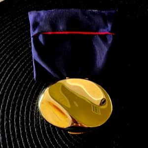 Estée Lauder Knowing gold tone face powder compact with satin pouch